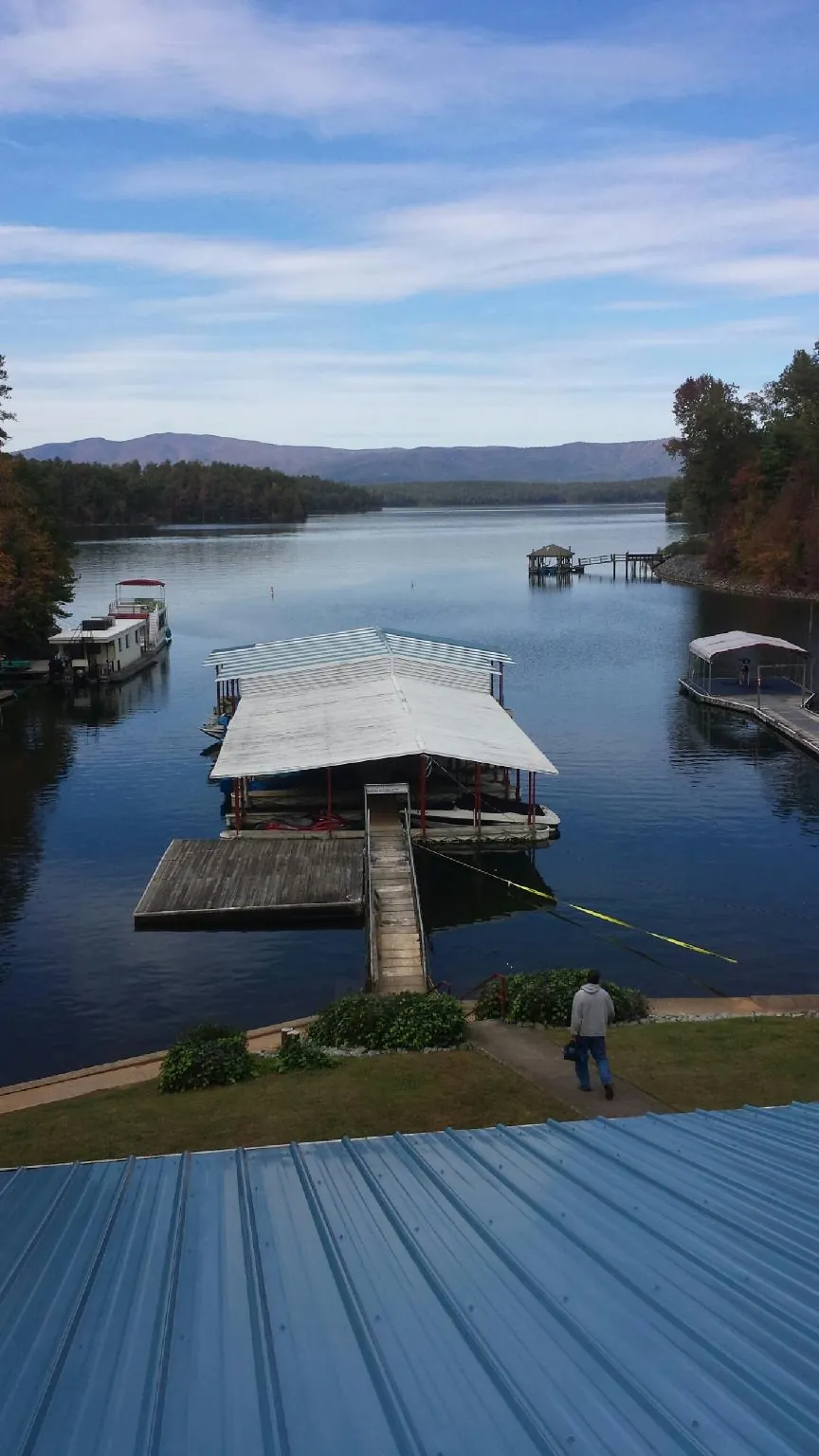 View across a lake from a newly installed blue metal roof in Sleepy Eye